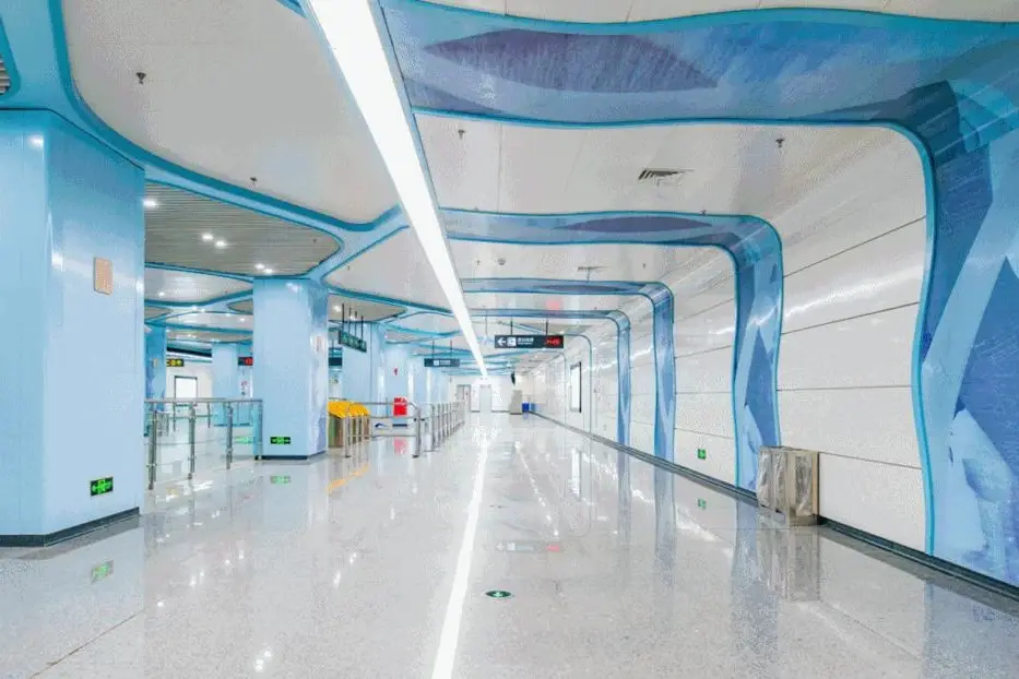 Metro station corridor with white and blue crystallized glass feature walls