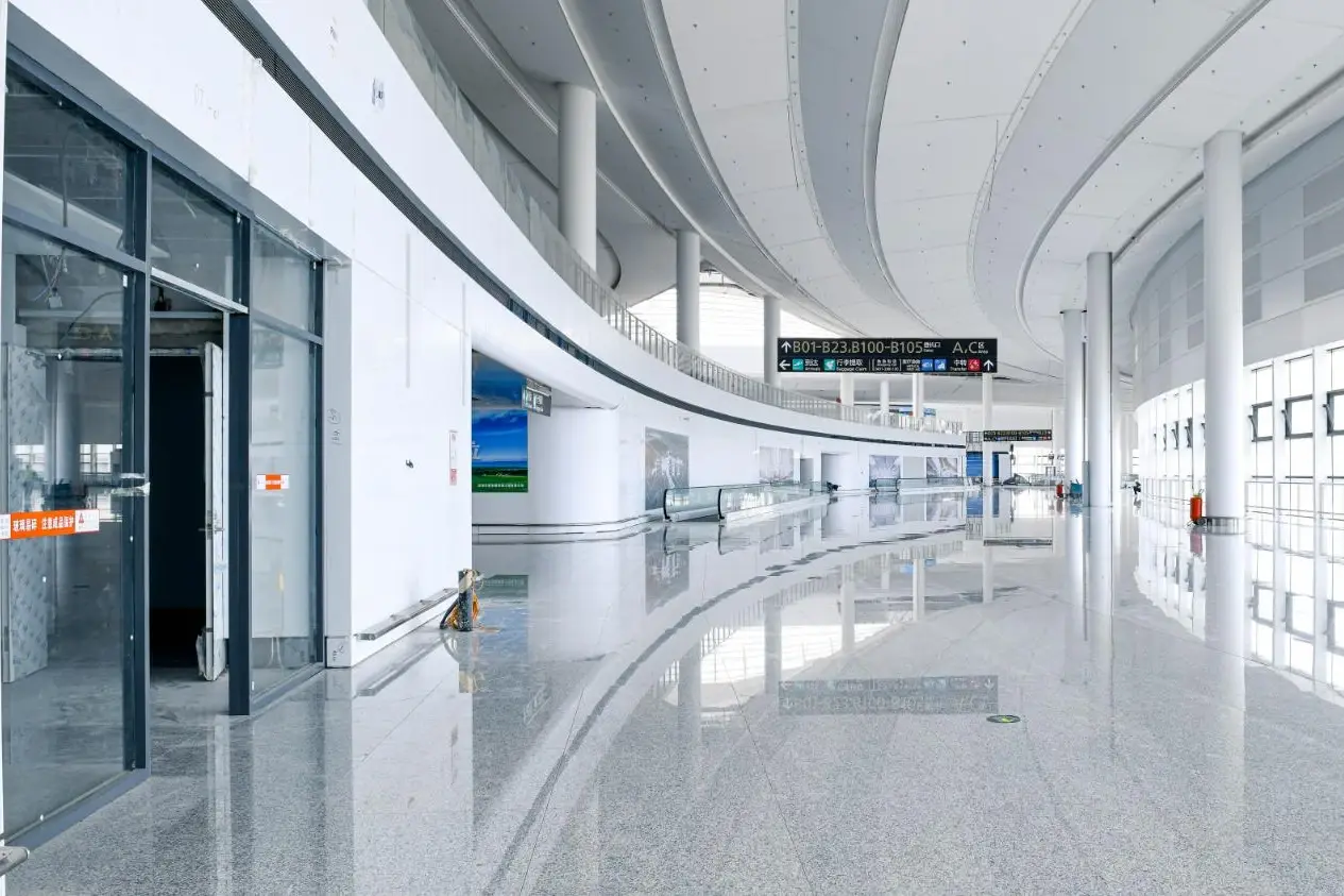 Hohhot Shengle International Airport concourse with white crystallized glass wall surfaces