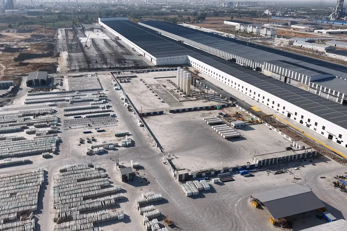 Aerial view of slab manufacturing buildings and rows of slabs in the stock yard