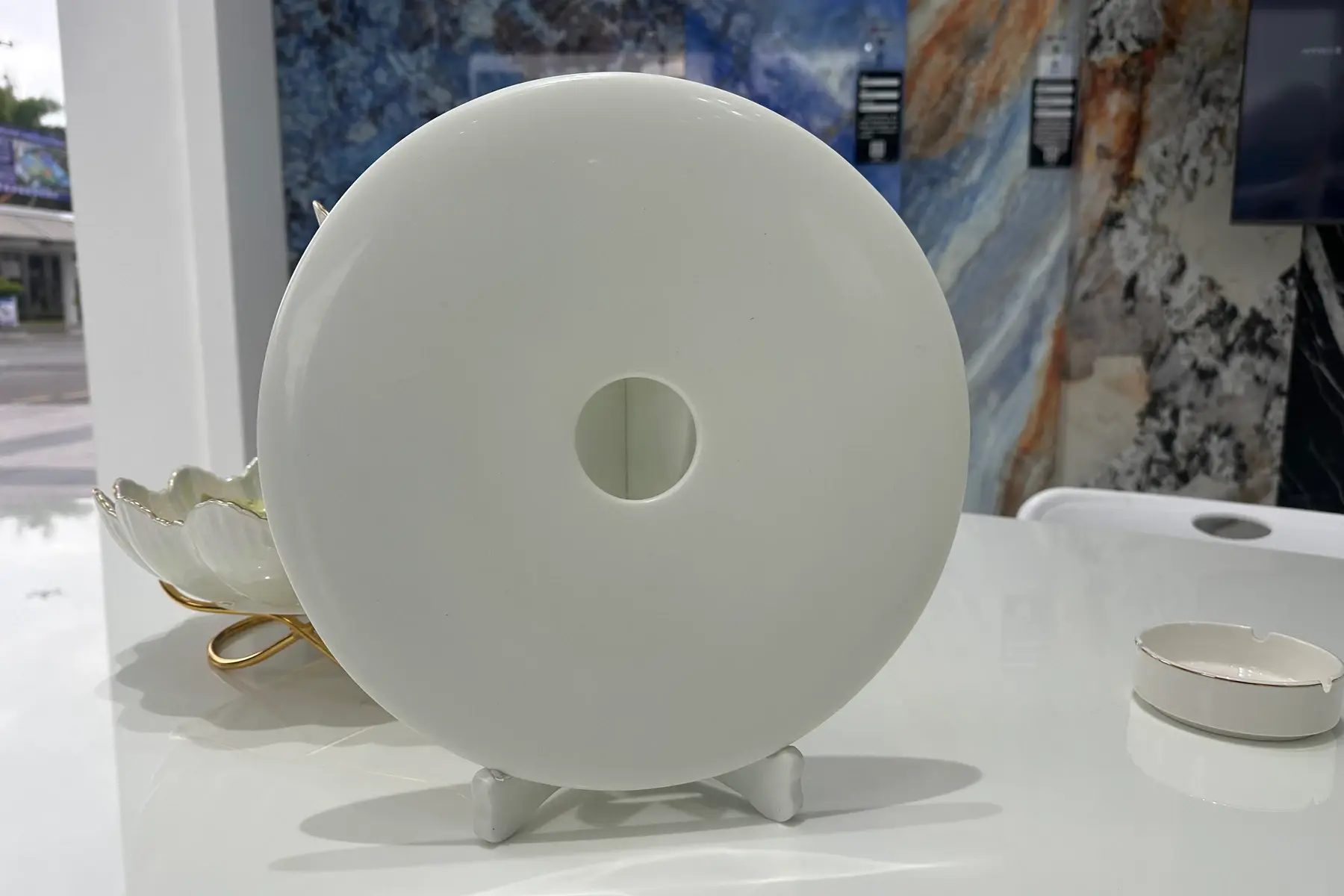 Thick white disc-shaped crystallized glass piece with a round centre hole