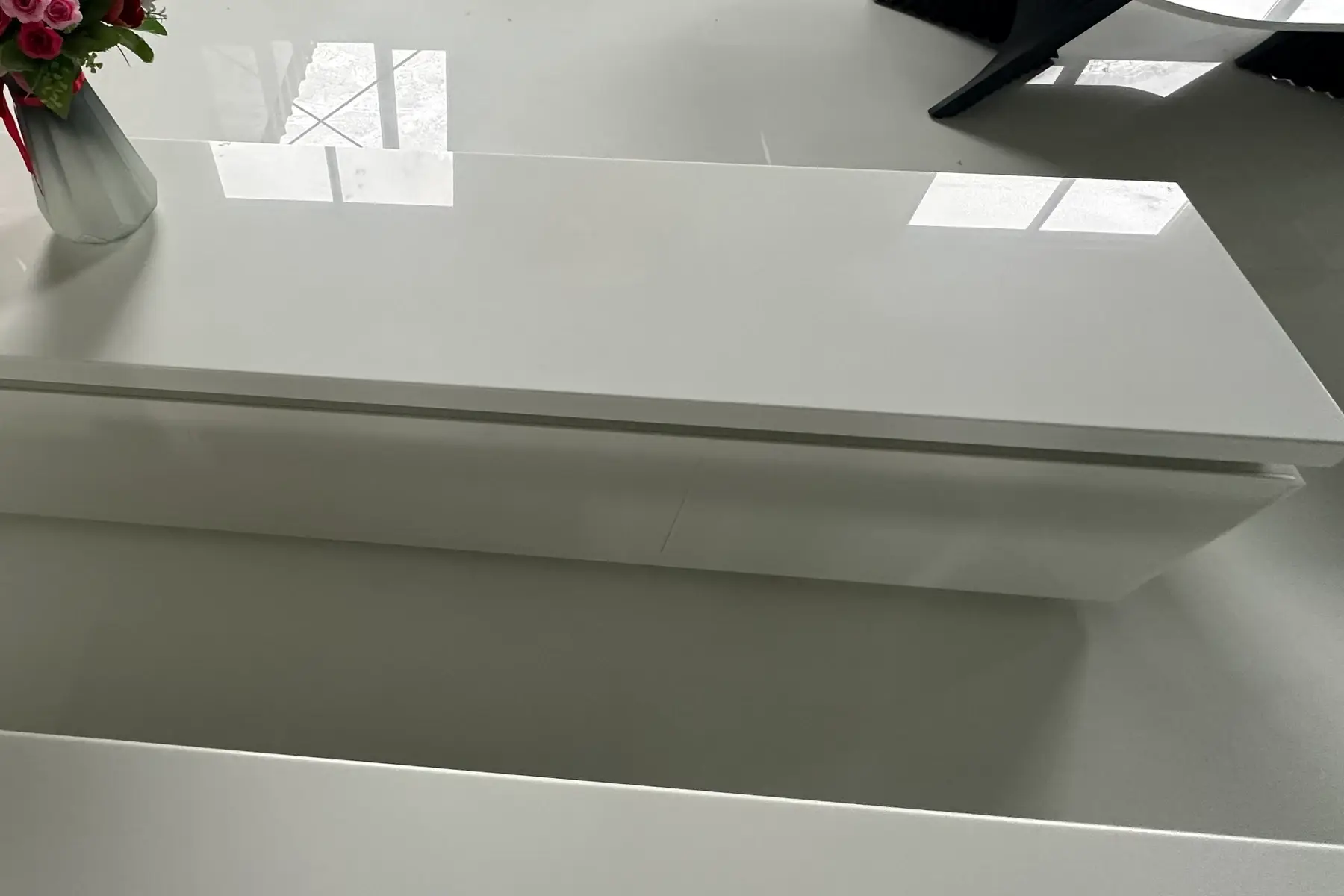 Thick white crystallized glass countertop with a crisp polished edge
